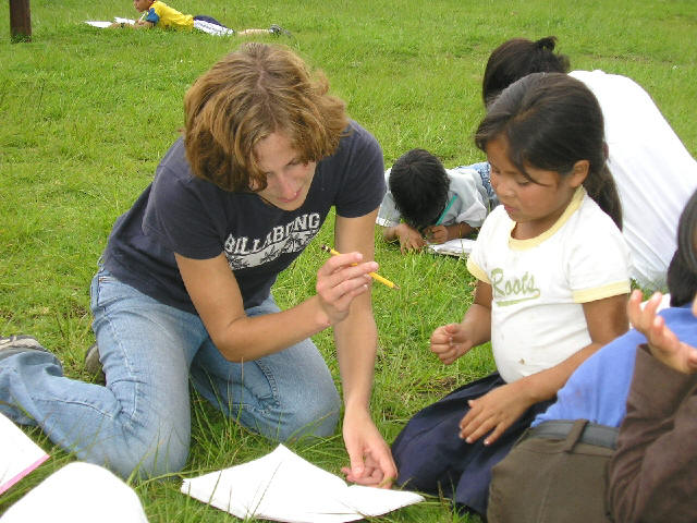 Spanish language students teaching and helping children with their school homework
